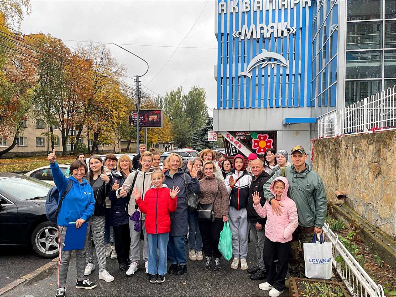 Діти з батьками біля будівлі аквапарку Маяк