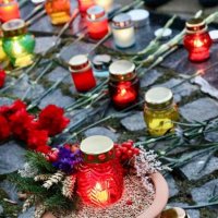 лампадки і квіти на постаменті пам'ятника жертвам Голодомору