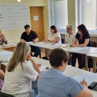 Група людей сидить за круглим столом